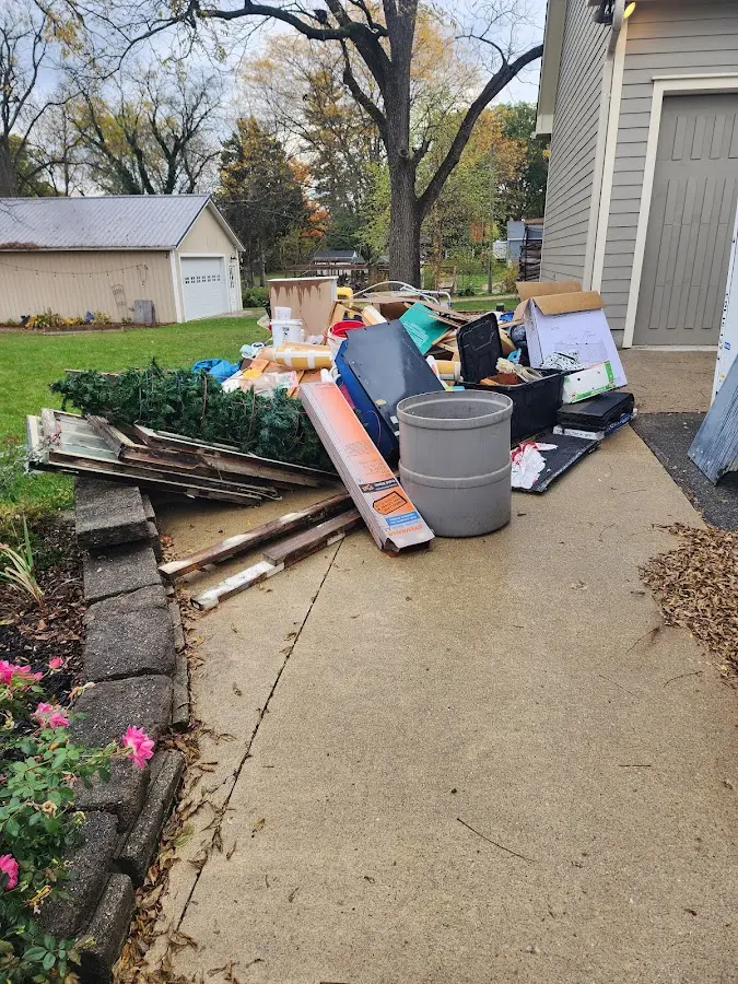 Dumpster being loaded with debris for Commercial Dumpster Rental in Frankfort